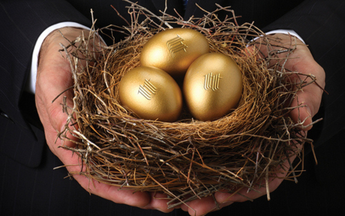 Man holding three golden eggs in a nest